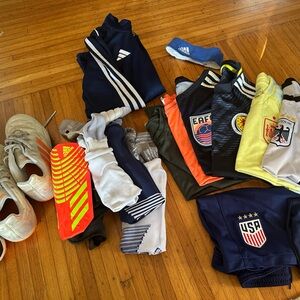 Bundle of soccer gear, size 8-10 boys: cleats, shin guards, jerseys, shorts, etc